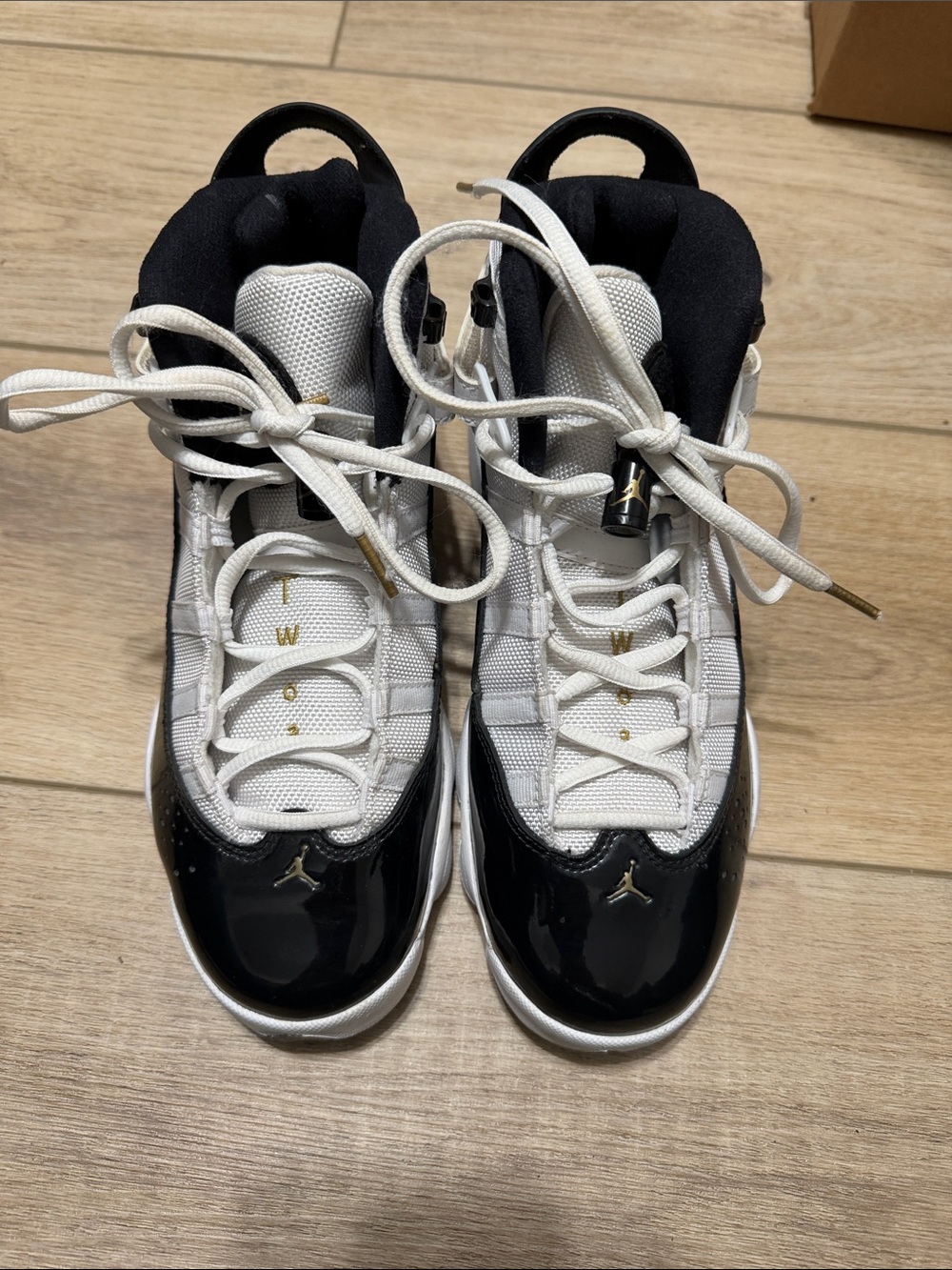 Jordan White and Black High-Top Sneakers with Gold Accents